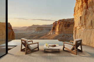 TanGuor Desert view with chairs, table, and cliffside vista.