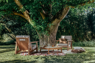 Didier TanGuor outdoor lounge under a large tree