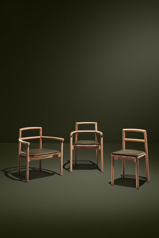 Didier chairs, three wooden armchairs and a side chair on display.