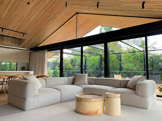 Modern living room with wood ceiling and large windows