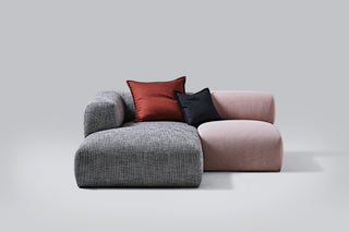 Gray and pink sectional sofa with two pillows.