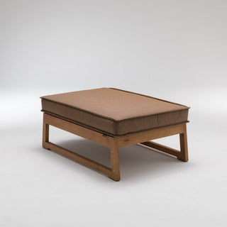 Wooden ottoman with brown cushion.