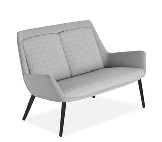Gray sofa with quilted design on a white background