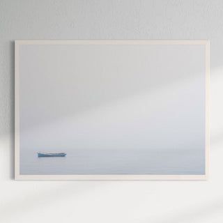 Blue boat in white frame on wall