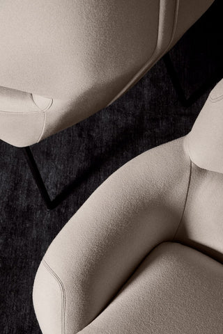 Beige chairs on dark rug, detail