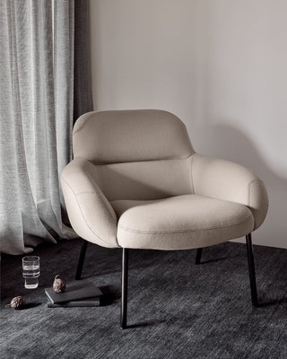 Beige armchair on dark rug