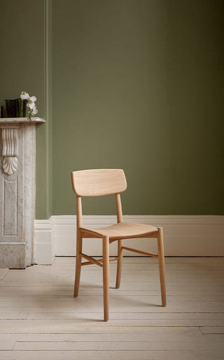 Ettiquette Collection wooden chair against olive green wall