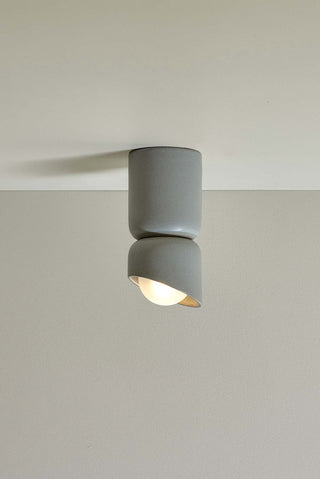 Marz Designs Terra 1.5 Surface Sconce in Fog with frosted bulb, portrait view.