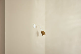 Marz Designs Terra 1 articulating lamp, chartreuse & white satin on wall.