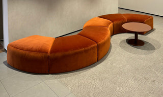 Orange curved sofa with table, photo from 7/3/2025