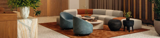 Modern living room with blue chairs and sectional sofa.