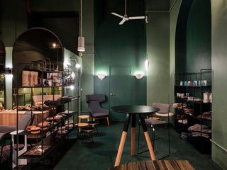 Interior retail space with green walls and furniture.