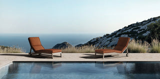 TanGuor chaise lounges by the pool.