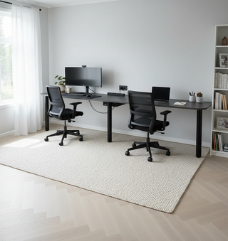 Modern home office with two desks, chairs, and a computer setup.