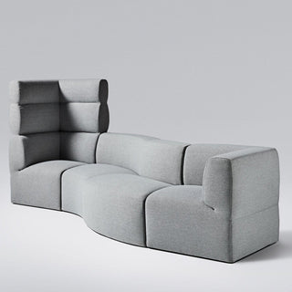 Gray modular sofa with curved design.