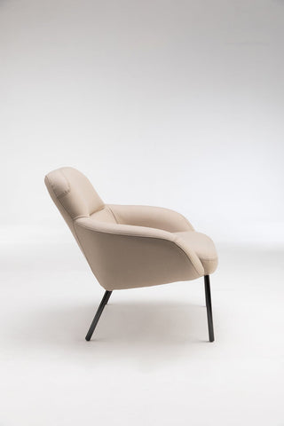 Beige armchair with black legs.