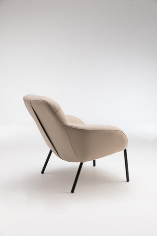 Beige armchair with black legs.