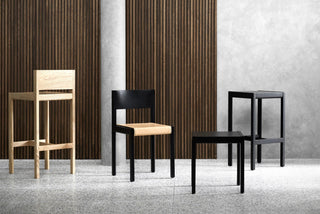 Four wooden chairs in a room.