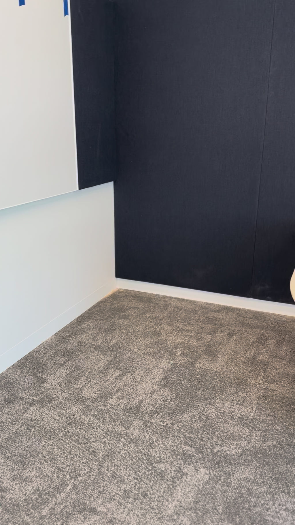Drum base against a blue fabric wall