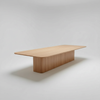 Wooden conference table on a light gray background
