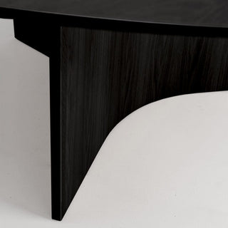 Close-up of dark wood table leg