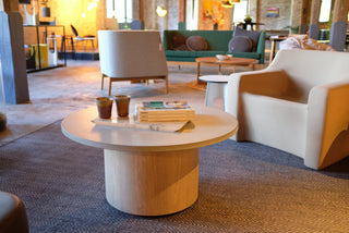 Modern lounge area with round coffee table and armchairs