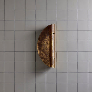 Marz Designs Furl Circle Wall Light, raw brass patina, on wall