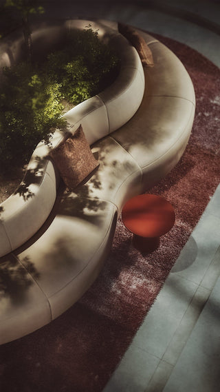 Curved sofa and red side table