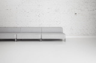 Ross Didier Corporate Collection - Modern gray sofa in white room