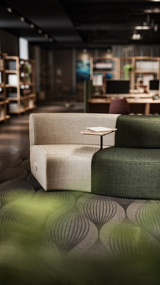 Two-tone sofa with small table in a modern lounge area.