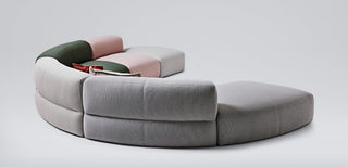 Modern curved sectional sofa in grey and pastel colors